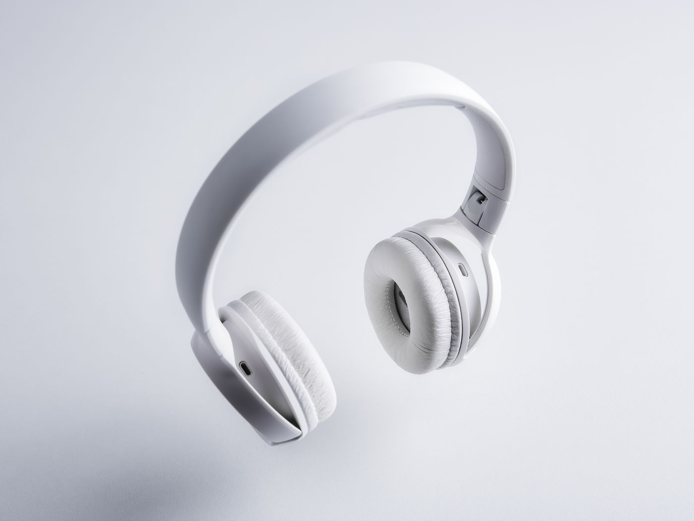 Minimal over-ear headphones on a neutral surface